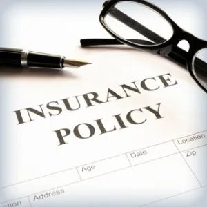 Photo: Insurance Policy print out and pair of glasses